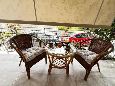 two chairs and a table on a balcony at Sirius Escape in Spáta