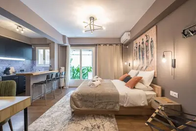 a bedroom with a bed and a kitchen at Athens Seaside Retreat Floisvos in Athens
