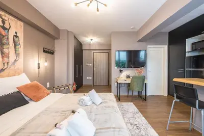 a bedroom with a large bed and a desk at Athens Seaside Retreat Floisvos in Athens