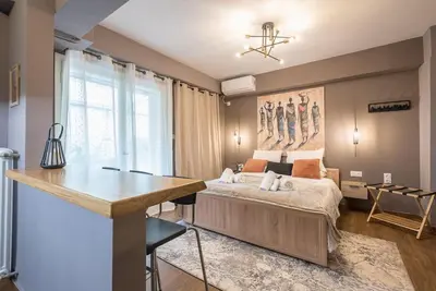 a bedroom with a bed and a desk in it at Athens Seaside Retreat Floisvos in Athens