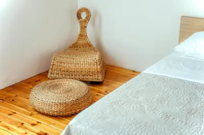 two baskets sitting on a wooden floor next to a bed at Alexandros suite in Athens