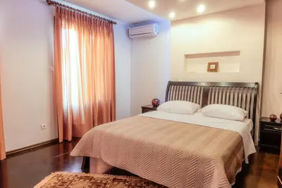 a bedroom with a bed and a large window at Alexandros suite in Athens