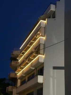 a building with lights on the side of it at Cozy Apartments near the Port of Piraeus in Piraeus