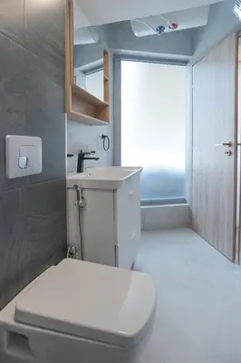 a bathroom with a toilet and a sink and a window at Cozy Apartments near the Port of Piraeus in Piraeus
