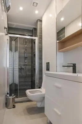 a bathroom with a shower and a toilet and a sink at Cozy Apartments near the Port of Piraeus in Piraeus