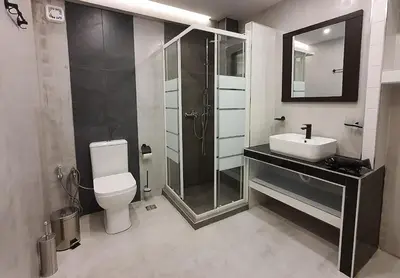 a bathroom with a toilet and a sink and a shower at Cozy Apartments near the Port of Piraeus in Piraeus