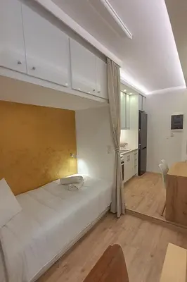 a bedroom with a large white bed in a room at Cozy Apartments near the Port of Piraeus in Piraeus