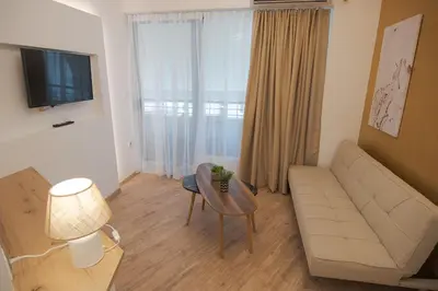 a living room with a couch and a table at Cozy Apartments near the Port of Piraeus in Piraeus