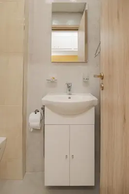 a bathroom with a white sink and a mirror at Cozy Apartments near the Port of Piraeus in Piraeus