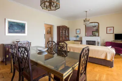 a room with a bed and a glass table and chairs at Spacious Apt Next to Marina Flisvo in Athens