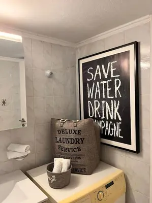 a bathroom with a sign that says save water drink and dance at Athena3 in Athens