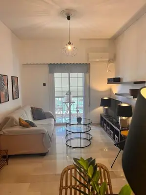 a living room with a couch and a table at Athena3 in Athens
