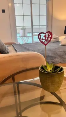 a table with a heart on a stick in a room at Athena3 in Athens