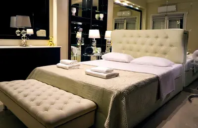 a bedroom with a large bed with towels on it at Sea Breeze Beachfront Apartment VIPGreece in Athens
