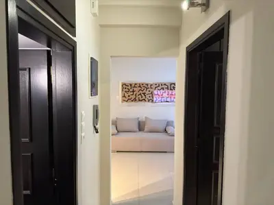 a hallway leading to a living room with a couch at Sea Breeze Beachfront Apartment VIPGreece in Athens