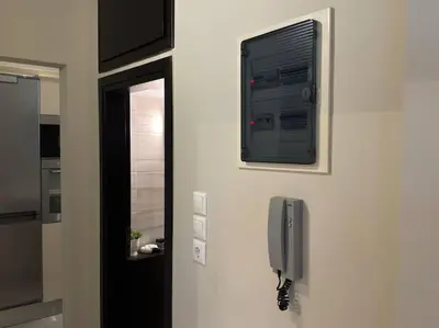 a room with a window and a phone on a wall at Sea Breeze Beachfront Apartment VIPGreece in Athens