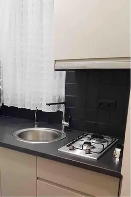 a kitchen counter with a sink and a stove at Special studio in the heart of Athens! in Athens