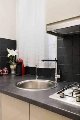 a kitchen counter with a sink and a stove at Special studio in the heart of Athens! in Athens