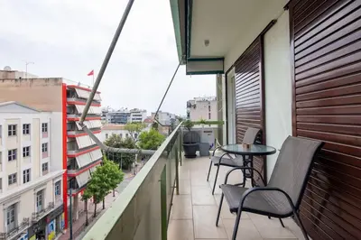 a balcony with a table and chairs on a building at Majestic and spacious apartment near Acropolis in Athens