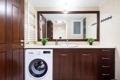 a bathroom with a washing machine and a sink at Majestic and spacious apartment near Acropolis in Athens