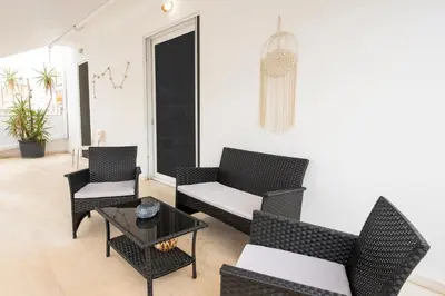 a living room with two chairs and a table at Athinais in Athens