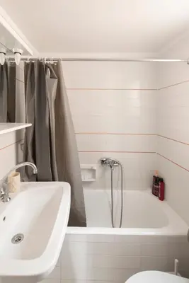 a bathroom with a tub and a sink and a toilet at Athinais in Athens
