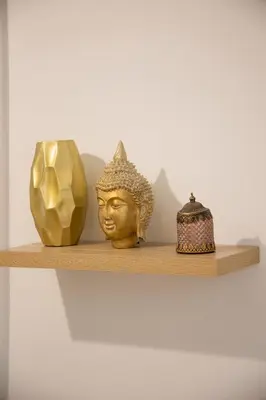 three vases and a statue on a shelf at Athinais in Athens