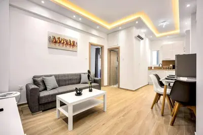 a living room with a couch and a table at Artemis Modern Apartment in Athens