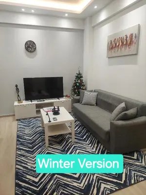 a living room with a couch and a christmas tree at Artemis Modern Apartment in Athens