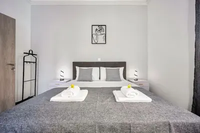 a bedroom with a bed with two towels on it at Artemis Modern Apartment in Athens