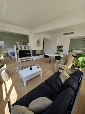 a living room with a couch and a table at Athenian Spirit by Acropolis in Athens