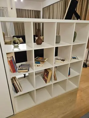 a white book shelf filled with books at Athenian Spirit by Acropolis in Athens