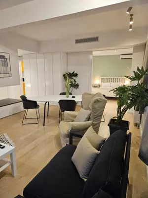 a living room with a couch and a table at Athenian Spirit by Acropolis in Athens