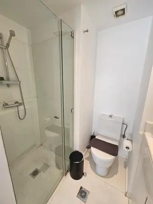 a bathroom with a toilet and a glass shower at Athenian Spirit by Acropolis in Athens