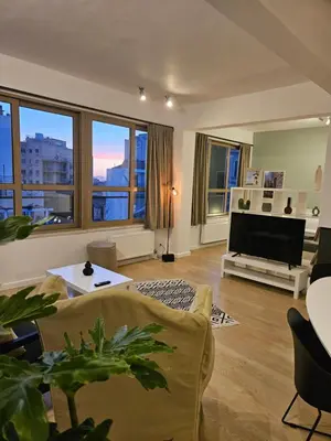 a living room with a couch and a television at Athenian Spirit by Acropolis in Athens