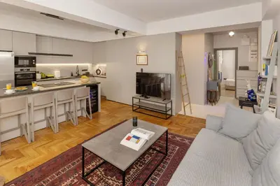 a living room with a couch a table and a kitchen at Well-designed apartment by the Acropolis GHH in Athens