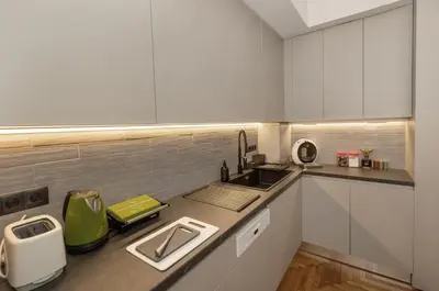 a kitchen with white cabinets and a sink at Well-designed apartment by the Acropolis GHH in Athens