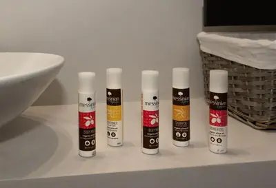 a group of four bottles on a counter in a bathroom at Well-designed apartment by the Acropolis GHH in Athens