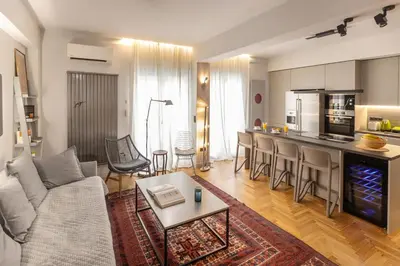 a living room with a couch and a kitchen at Well-designed apartment by the Acropolis GHH in Athens