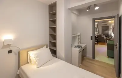 a bedroom with a bed and a room with a hallway at Well-designed apartment by the Acropolis GHH in Athens