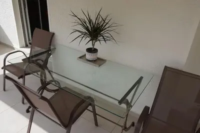 a glass table and a chair with a potted plant at Urban Apartment Psiri in Athens