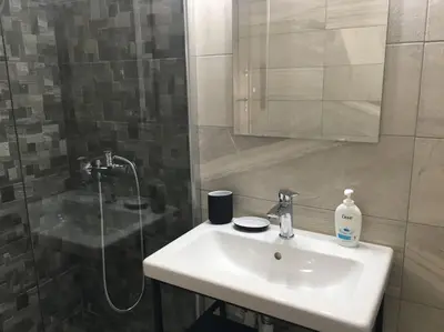 a bathroom with a sink and a shower at Urban Apartment Psiri in Athens