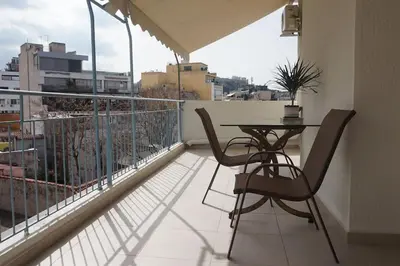 a balcony with a table and chairs on a balcony at Urban Apartment Psiri in Athens