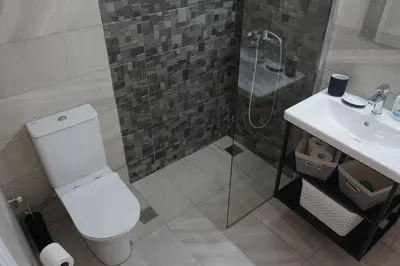 a bathroom with a shower and a toilet and a sink at Urban Apartment Psiri in Athens