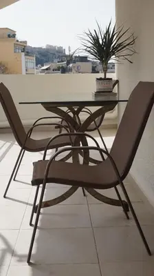 a table and chair with a potted plant on it at Urban Apartment Psiri in Athens