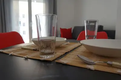 a wooden table with two glasses and bowls on it at Urban Apartment Psiri in Athens