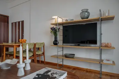 a living room with a flat screen tv on a wall at Dylan in Athens