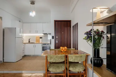 a kitchen with a table and chairs and a refrigerator at Dylan in Athens