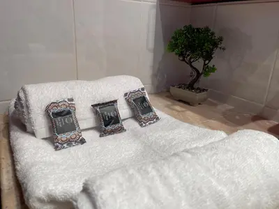 a white bed with four pillows on top of it at Sounio Poseidon Villa in Sounio