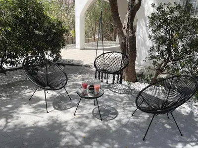 three black chairs and a table with drinks on it at Sounio Poseidon Villa in Sounio